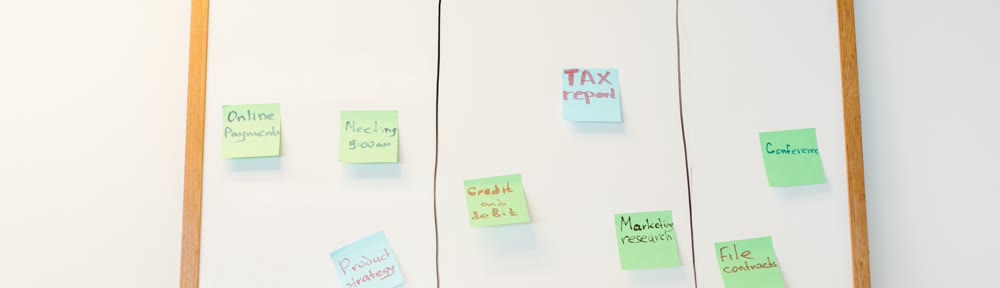 Kanban workflow board with sticky notes tracking business system tasks